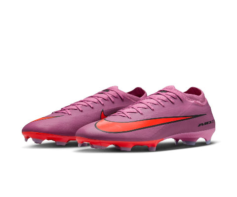 Pink soccer cleats with red accents on a white background